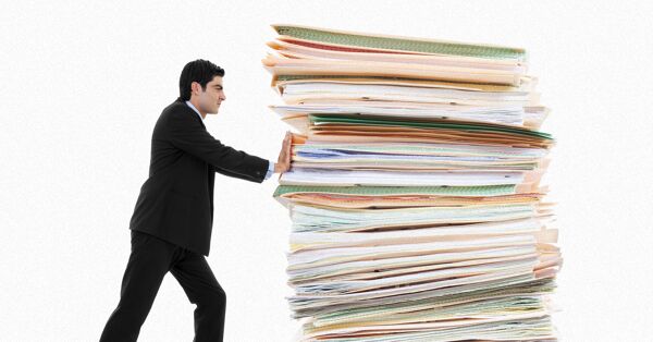 An employee pushing a pile of paper