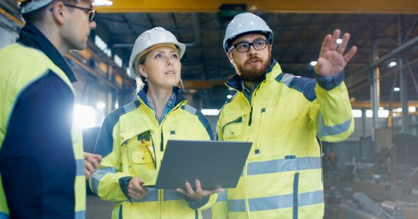 A team of workers planning inside a factory