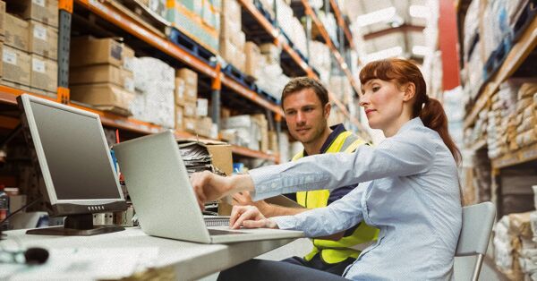 Warehouse workers using a laptop computer