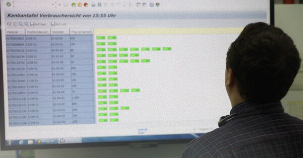 Worker looking at inventory data display
