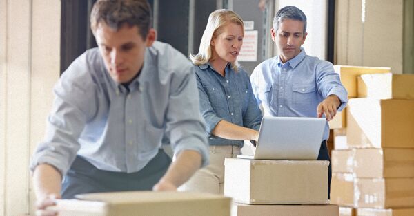 A group of worker preparing shipping boxes