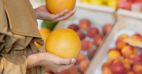 Woman holding two oranges