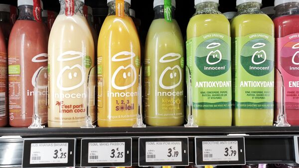 Shelf of bottled juice equipped with Newton ESL