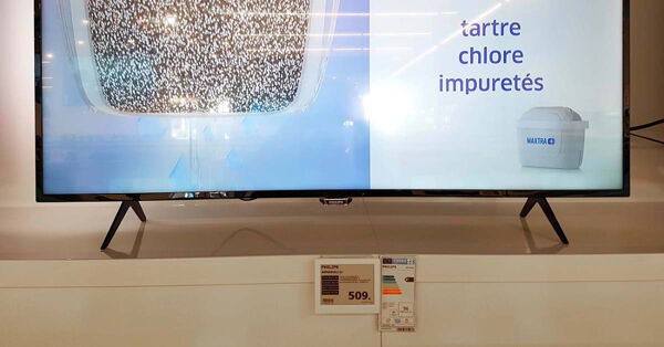 Flat screen TV with ESL label next to the paper one