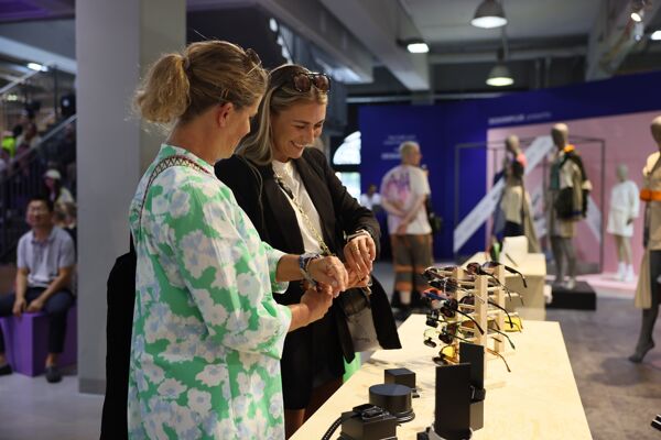 Two women smiled as they compared their watches.